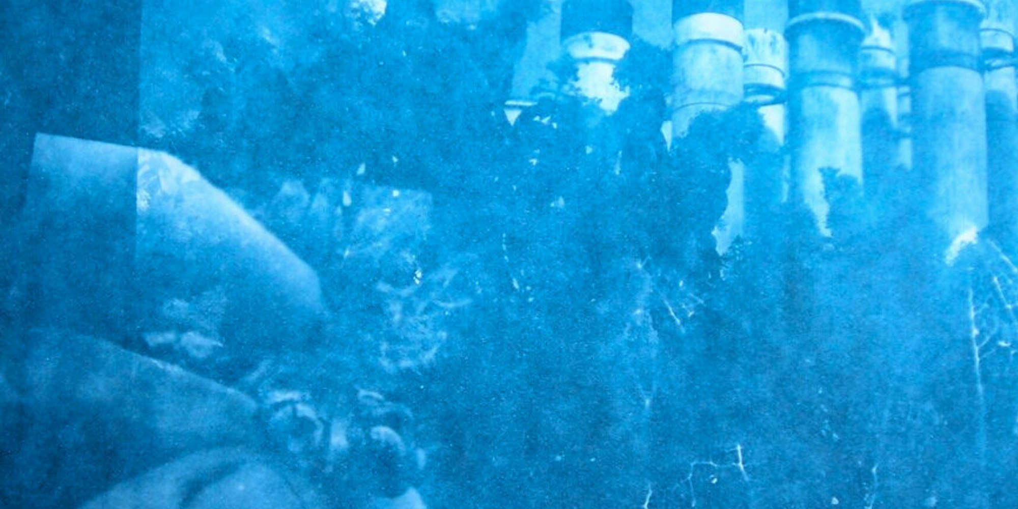 Blue abstract texture with vertical cylindrical shapes along the right edge.