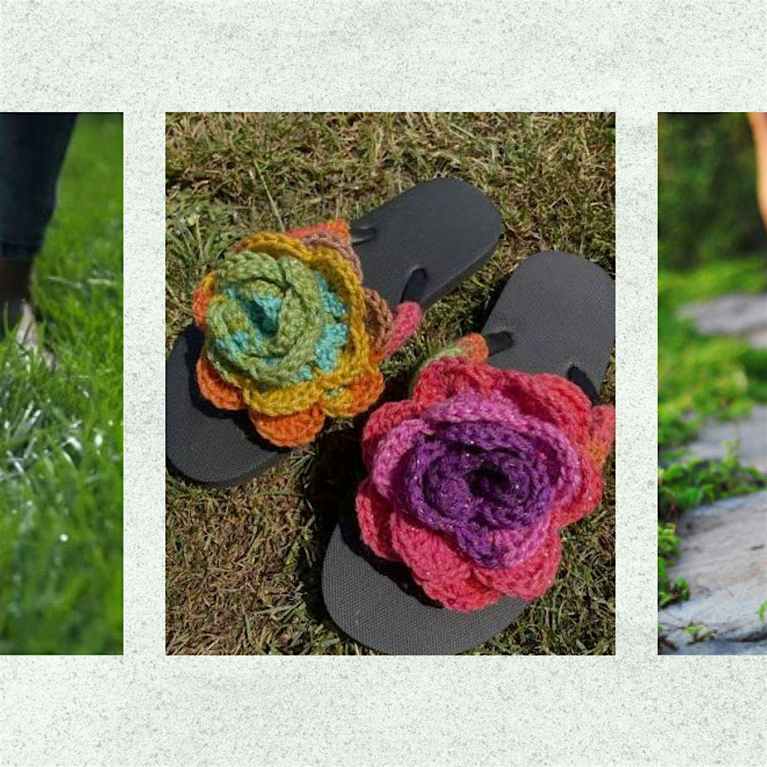 Colorful crocheted flower decorations placed on black flip-flops on grass ground outdoors.
