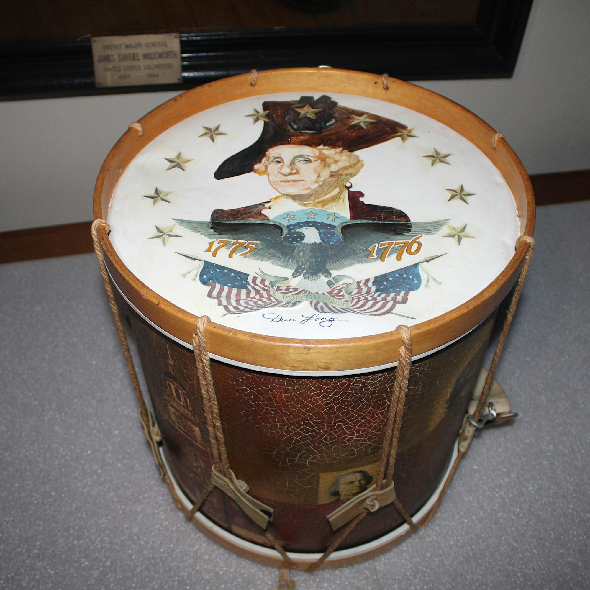 Decorative drum with a patriotic eagle image and the years 1775 and 1776, set in a brown leather case with rope handles.